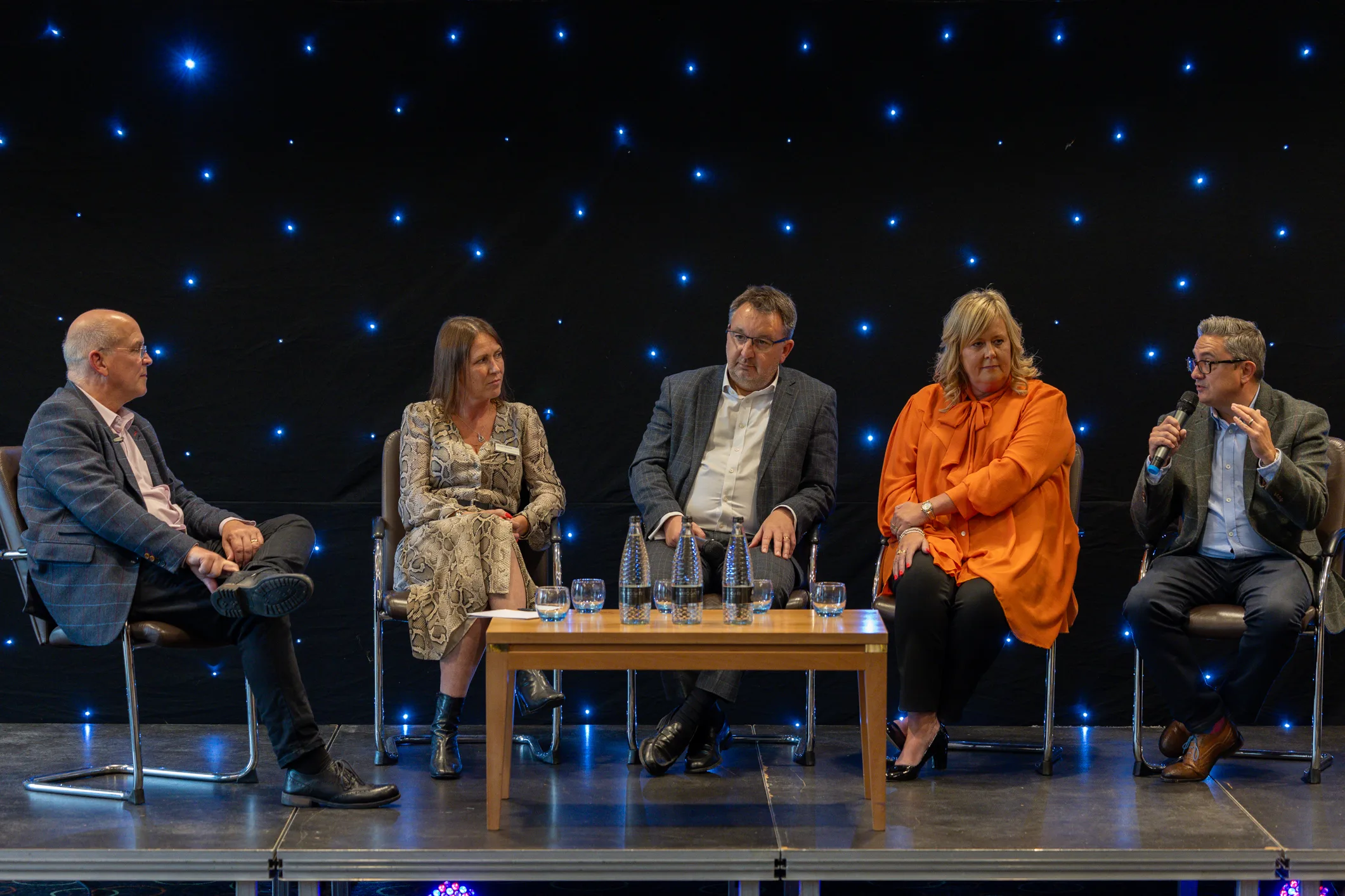 Panel discussion on a starcloth-backed stage