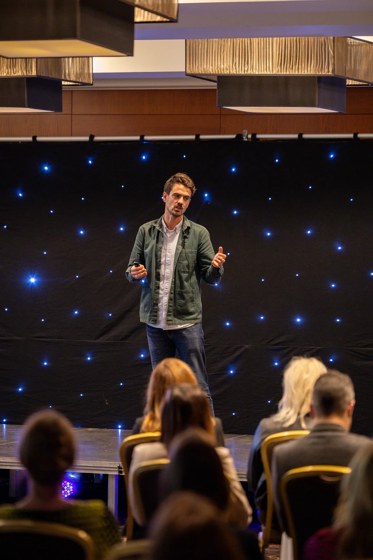 Live speaker performing on the illuminated stage
