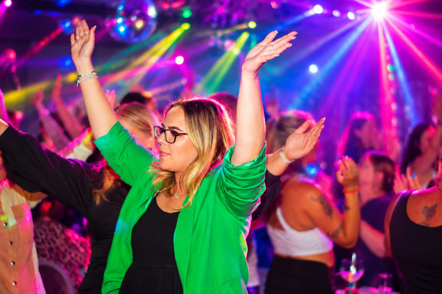 Guests dancing and raising their hands at Bingo Disco