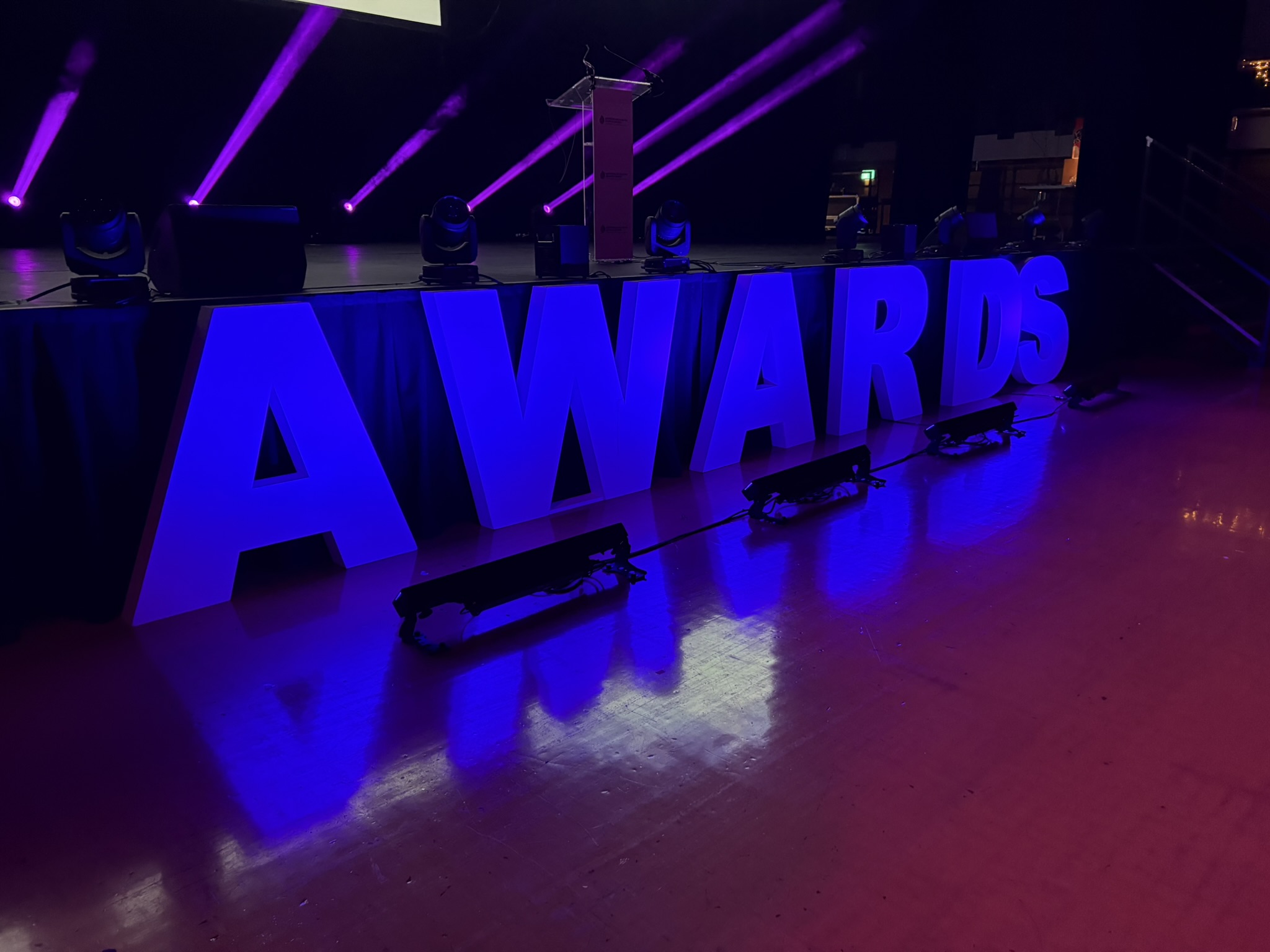 Now Entertain Me illuminated AWARDS letters at an event